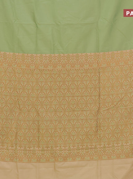 Semi banarasi katan saree pista green and cream with plain body and zari woven border