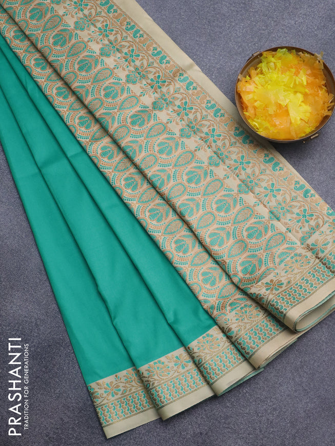 Semi banarasi katan saree teal blue and beige with plain body and zari woven border