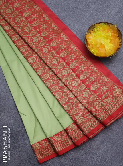 Semi banarasi katan saree pista green and red with plain body and zari woven border