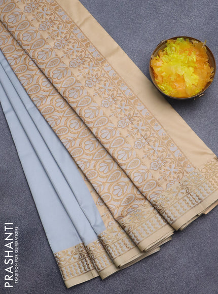 Semi banarasi katan saree pastel grey and sandal with plain body and zari woven border