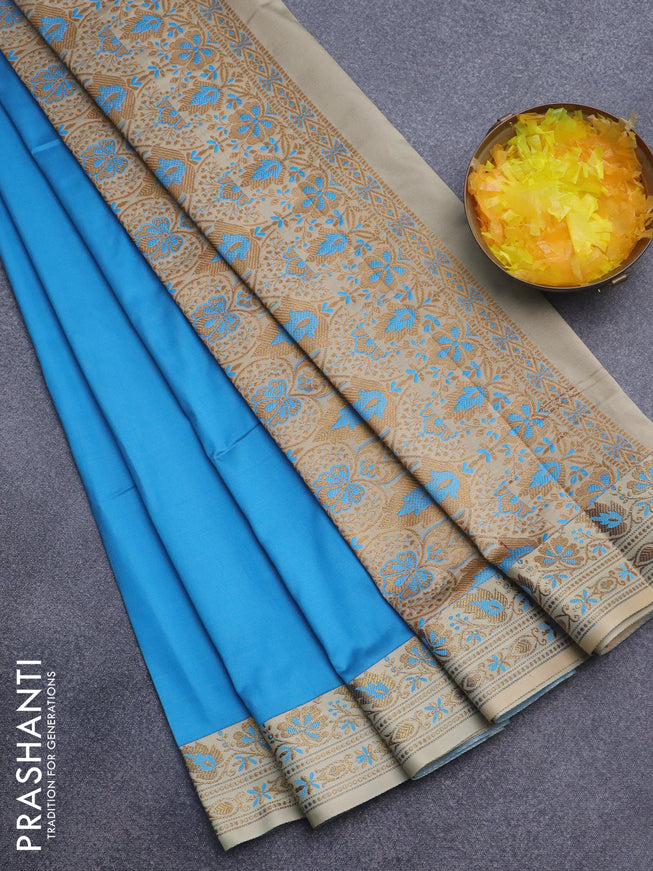 Semi banarasi katan saree cs blue and beige with plain body and zari woven border