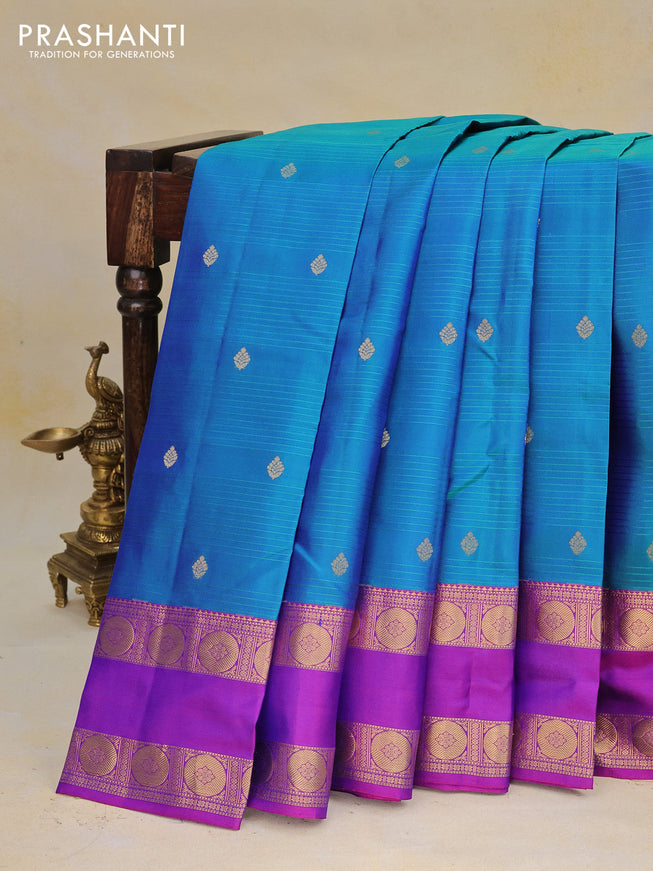 Pure kanchipuram silk saree dual shade of peacock green and purple with allover self emboss & zari buttas and rettapet zari woven border