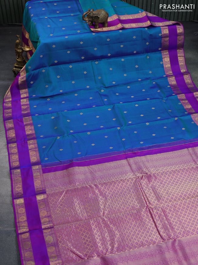 Pure kanchipuram silk saree dual shade of peacock green and purple with allover self emboss & zari buttas and rettapet zari woven border