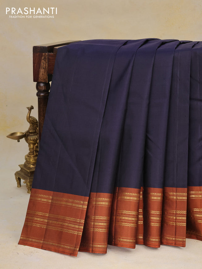 Pure kanchipuram silk saree navy blue and rustic orange with plain body and zari woven border