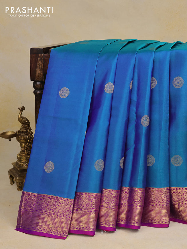 Pure kanchipuram silk saree dual shade of bluish green and purple with zari woven buttas and rich zari woven border