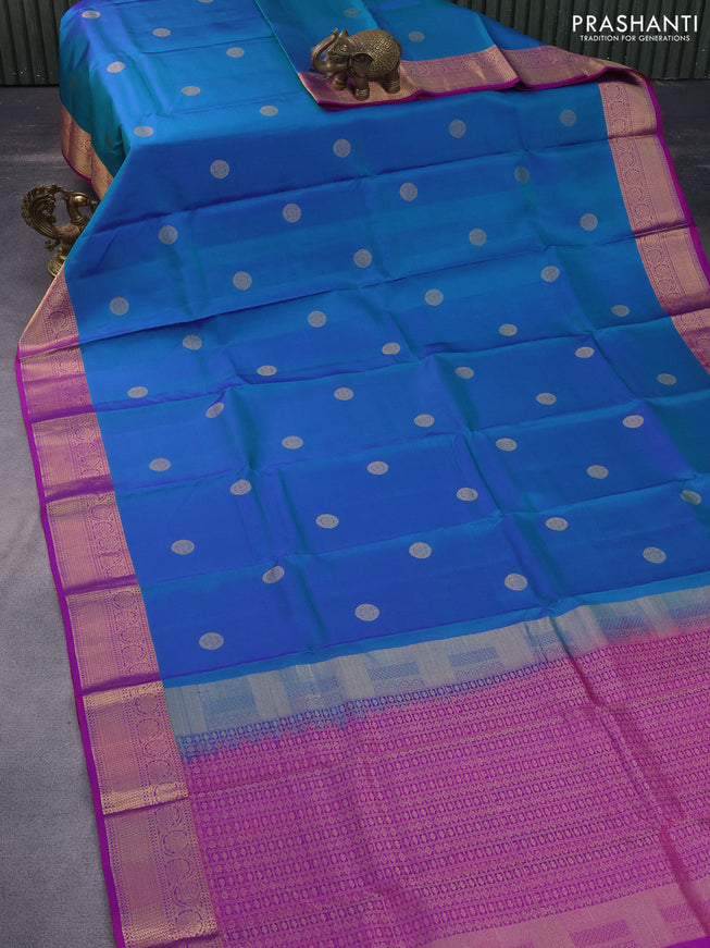 Pure kanchipuram silk saree dual shade of bluish green and purple with zari woven buttas and rich zari woven border