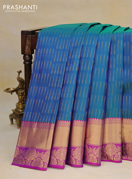 Pure kanchipuram silk saree dual shade of bluish green and purple with allover zari woven butta weaves and rich zari woven border