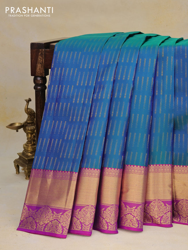 Pure kanchipuram silk saree dual shade of bluish green and purple with allover zari woven butta weaves and rich zari woven border