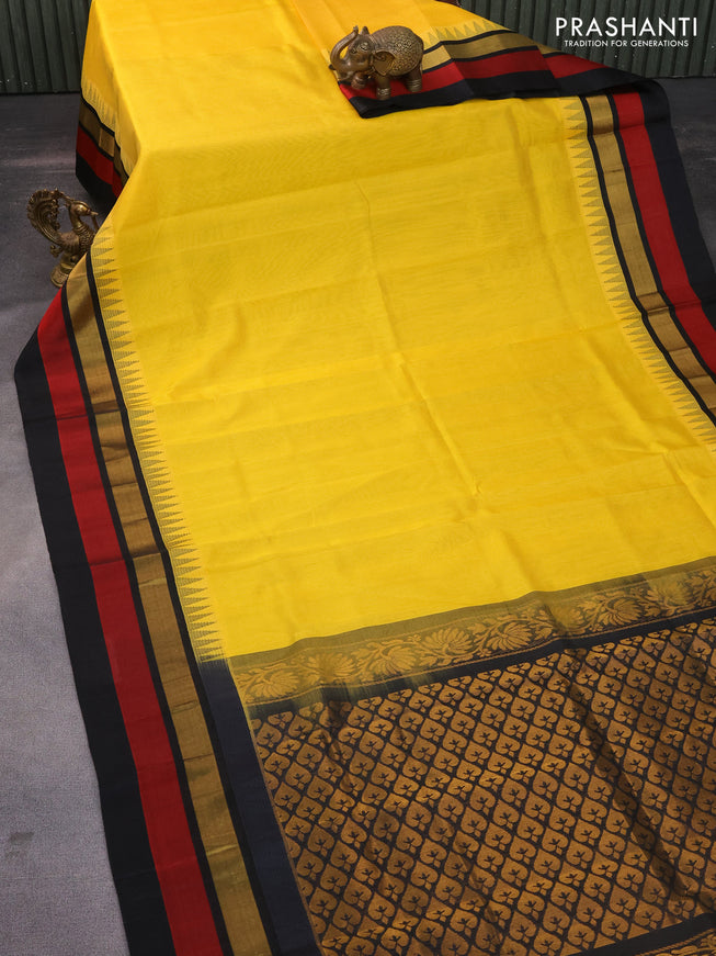 Kuppadam silk cotton saree yellow and black with plain body and temple design zari woven border