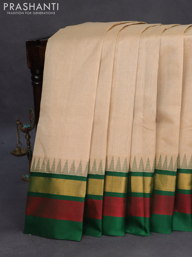 Kuppadam silk cotton saree beige and green with plain body and temple design zari woven border