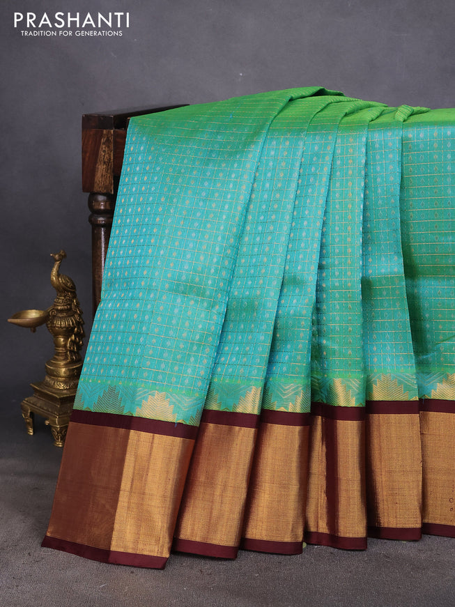 Kuppadam silk cotton saree dual shade of teal green shade and coffee brown with zari woven checks & buttas and long temple design zari woven border