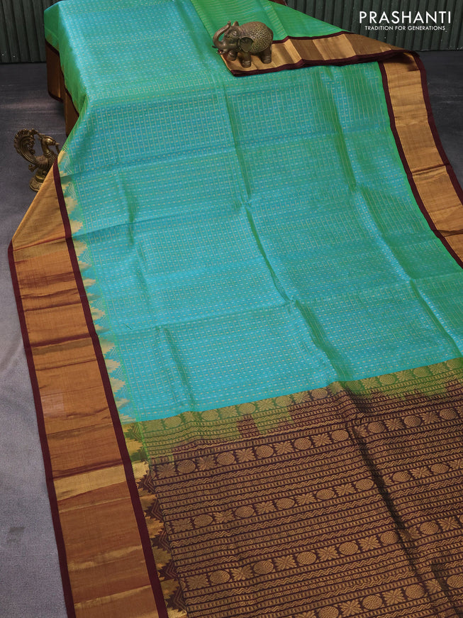 Kuppadam silk cotton saree dual shade of teal green shade and coffee brown with zari woven checks & buttas and long temple design zari woven border