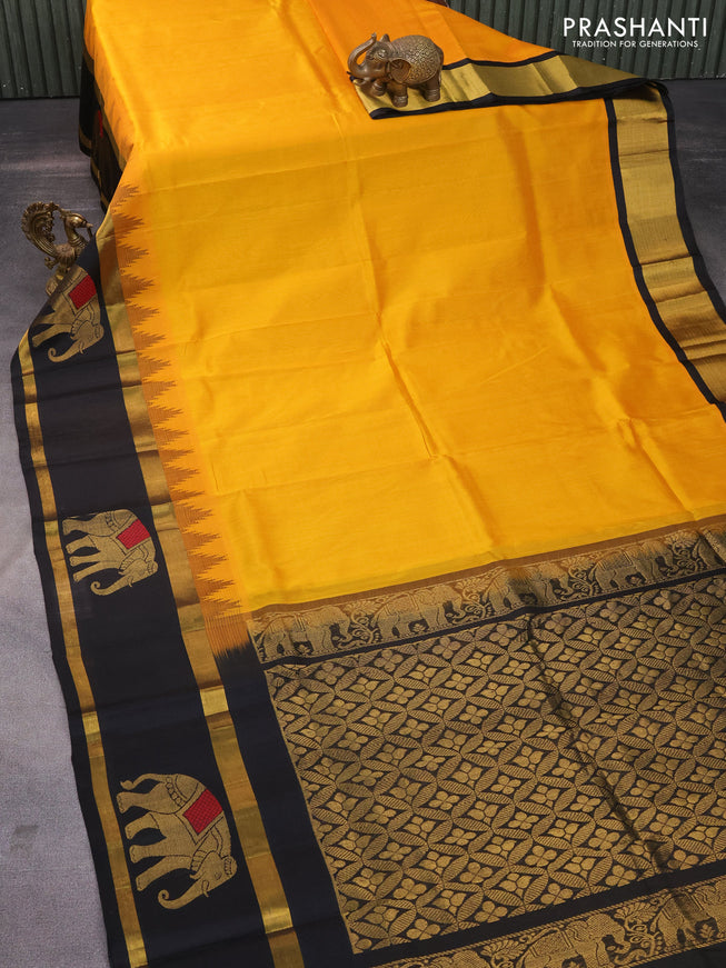 Kuppadam silk cotton saree mango yellow and black with plain body and temple design rettapet zari woven elephant butta border