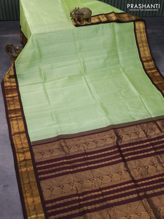 Silk cotton saree pista green and deep coffee brown with plain body and zari woven korvai border