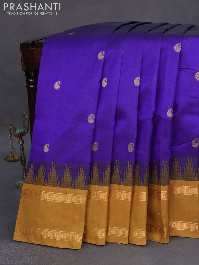 Silk cotton saree blue and dark mustard with zari woven paisley buttas and temple design rettapet zari woven korvai border