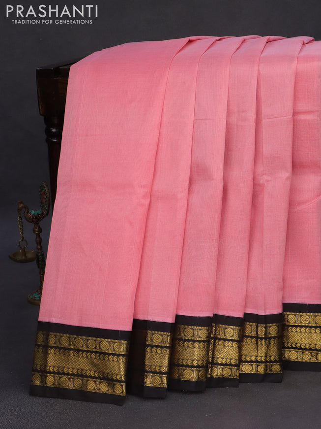 Silk cotton saree peach pink and black with plain body and zari woven korvai border