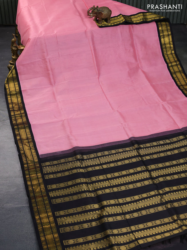 Silk cotton saree peach pink and black with plain body and zari woven korvai border