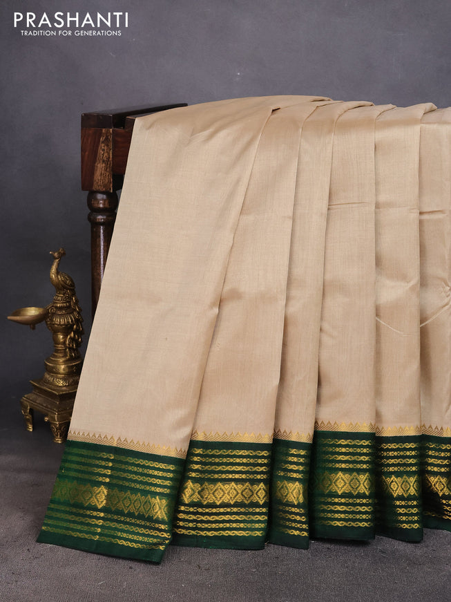 Silk cotton saree beige and green with plain body and zari woven korvai border