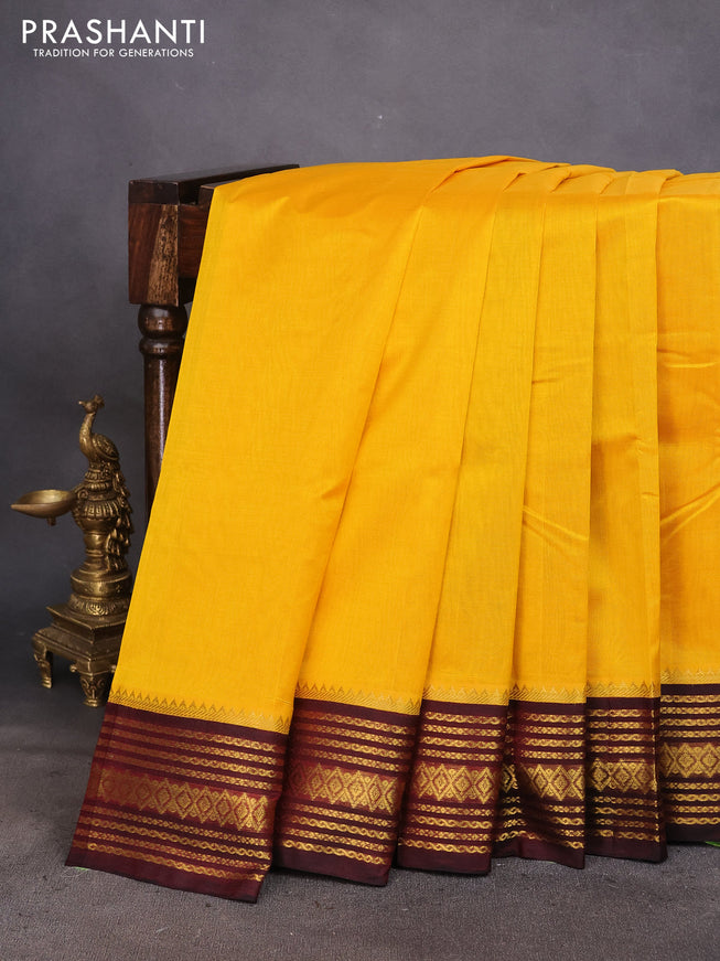 Silk cotton saree mango yellow and maroon with plain body and zari woven korvai border