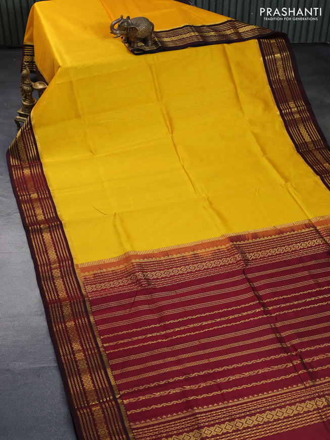 Silk cotton saree mango yellow and maroon with plain body and zari woven korvai border