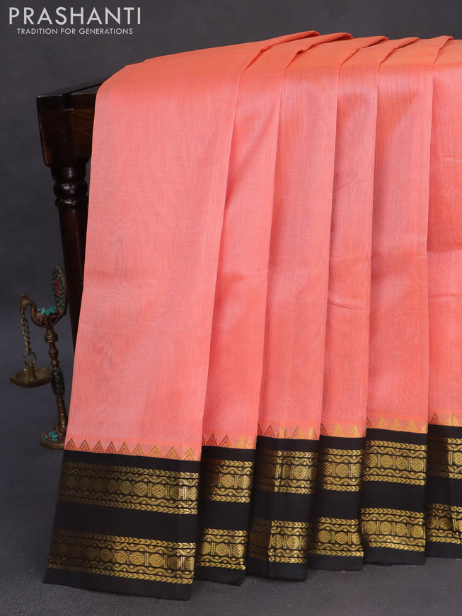 Silk cotton saree peach orange  and black with plain body and zari woven korvai border