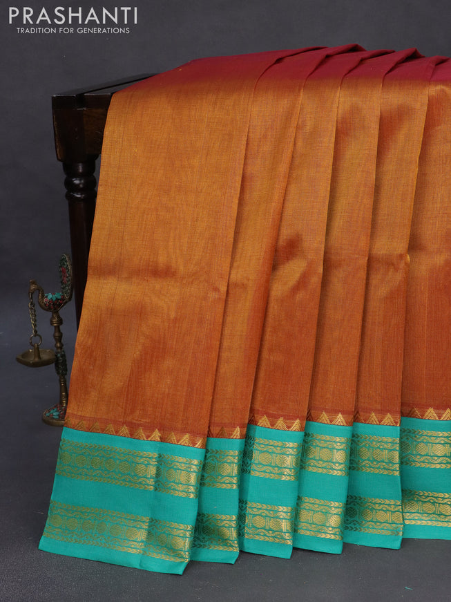 Silk cotton saree dual shade of dark mustard and teal blue with plain body and zari woven korvai border