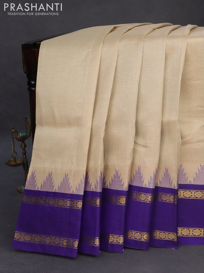 Silk cotton saree beige and blue with plain body and temple design rettapet zari woven korvai border