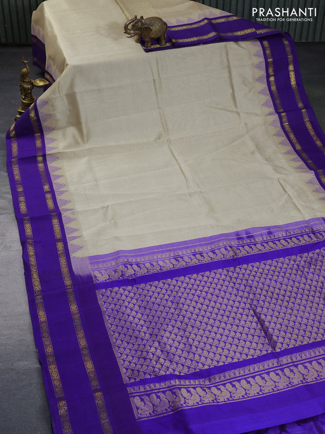 Silk cotton saree beige and blue with plain body and temple design rettapet zari woven korvai border