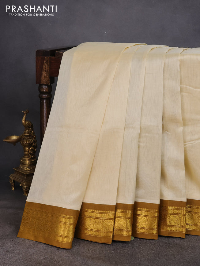 Silk cotton saree cream and mustard shade with plain body and zari woven annam korvai border