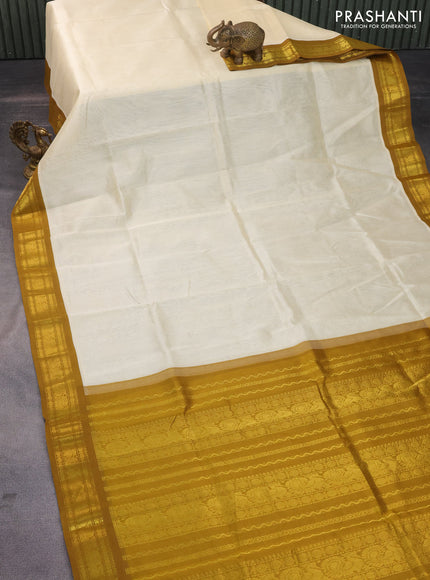 Silk cotton saree cream and mustard shade with plain body and zari woven annam korvai border