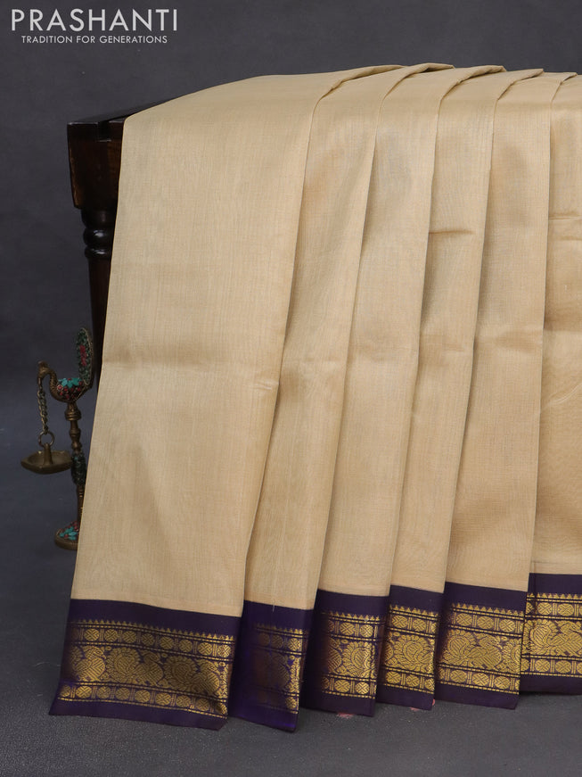 Silk cotton saree beige and blue with plain body and zari woven annam korvai border