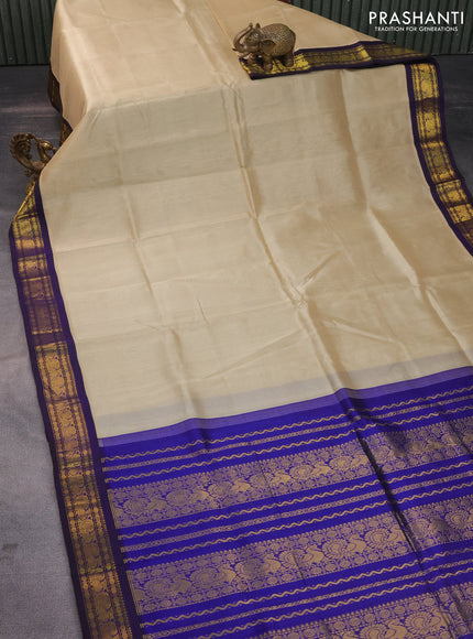 Silk cotton saree beige and blue with plain body and zari woven annam korvai border