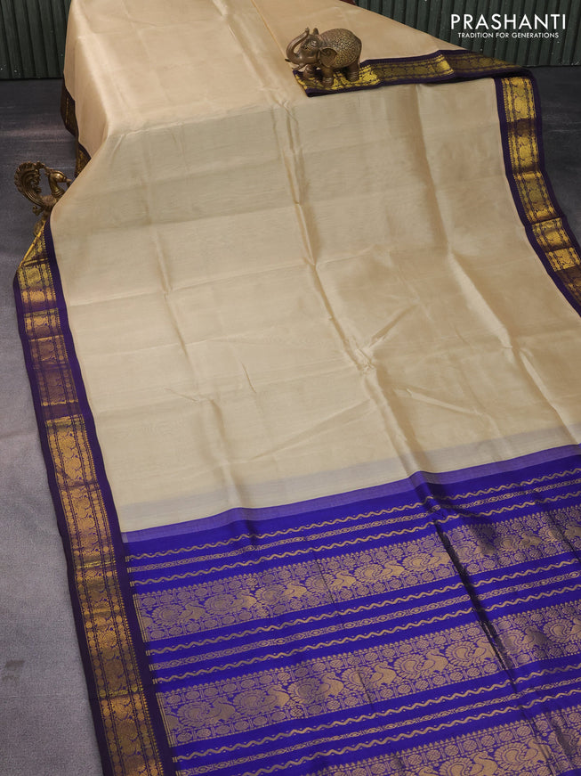 Silk cotton saree beige and blue with plain body and zari woven annam korvai border