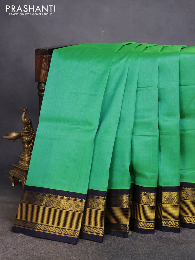 Silk cotton saree teal green shade and navy blue with plain body and zari woven korvai border