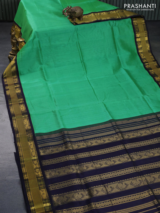 Silk cotton saree teal green shade and navy blue with plain body and zari woven korvai border