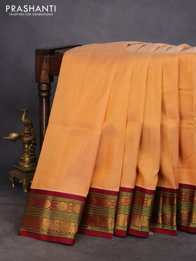 Silk cotton saree pale orange and maroon with plain body and zari woven korvai border