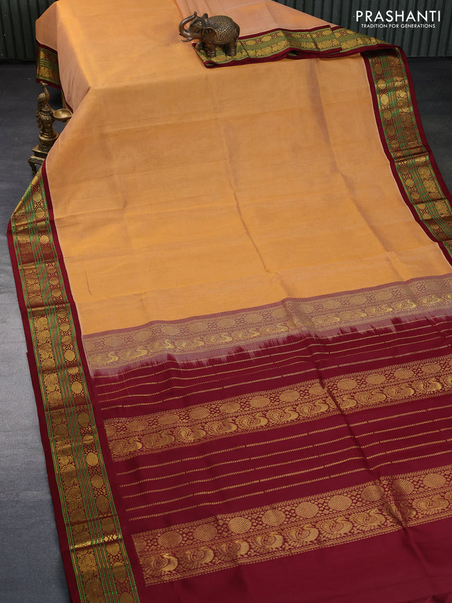 Silk cotton saree pale orange and maroon with plain body and zari woven korvai border