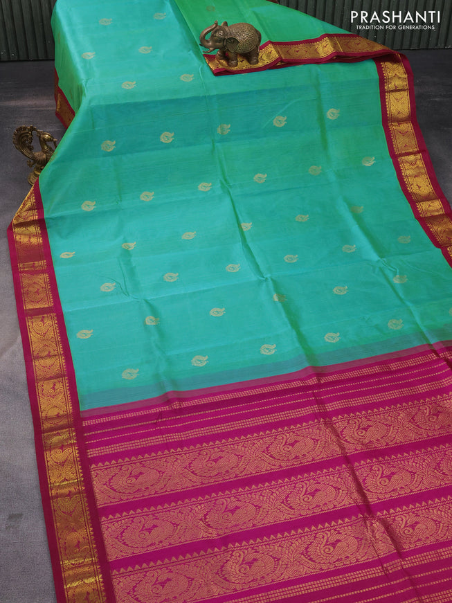 Silk cotton saree dual shade of teal green and magenta pink with zari woven annam buttas and zari woven korvai border