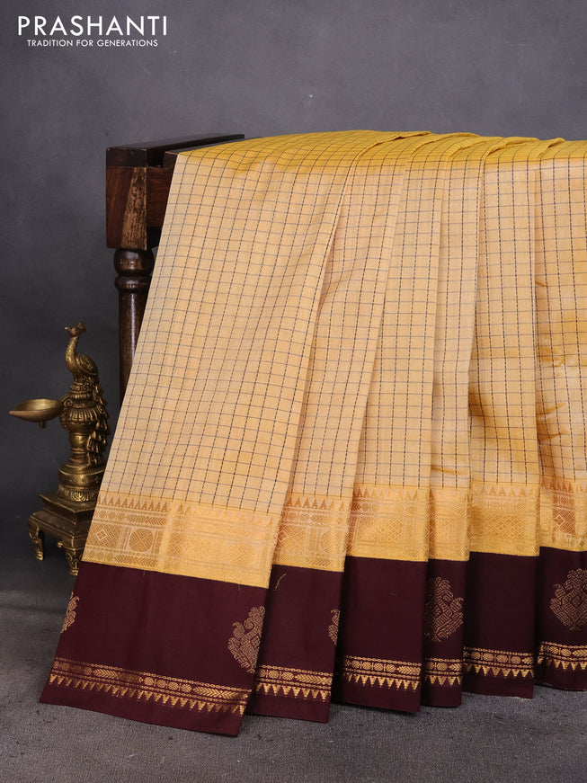 Silk cotton saree pale yellow and coffee brown with allover thread checked pattern and rettapet zari woven korvai butta border