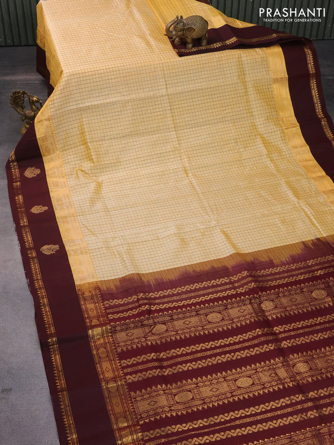 Silk cotton saree pale yellow and coffee brown with allover thread checked pattern and rettapet zari woven korvai butta border