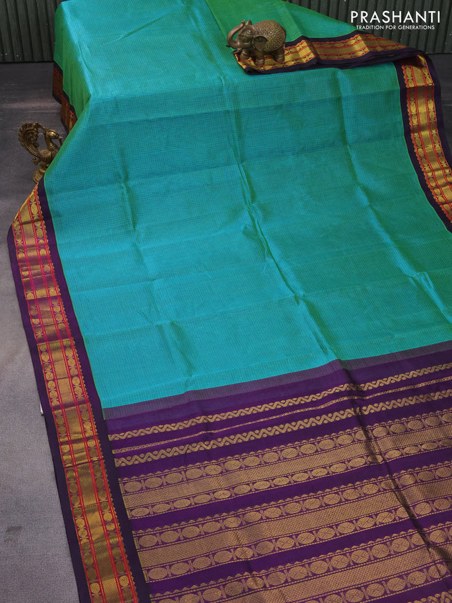 Silk cotton saree dual shade of teal green and deep violet with allover thread checked pattern and zari woven korvai border