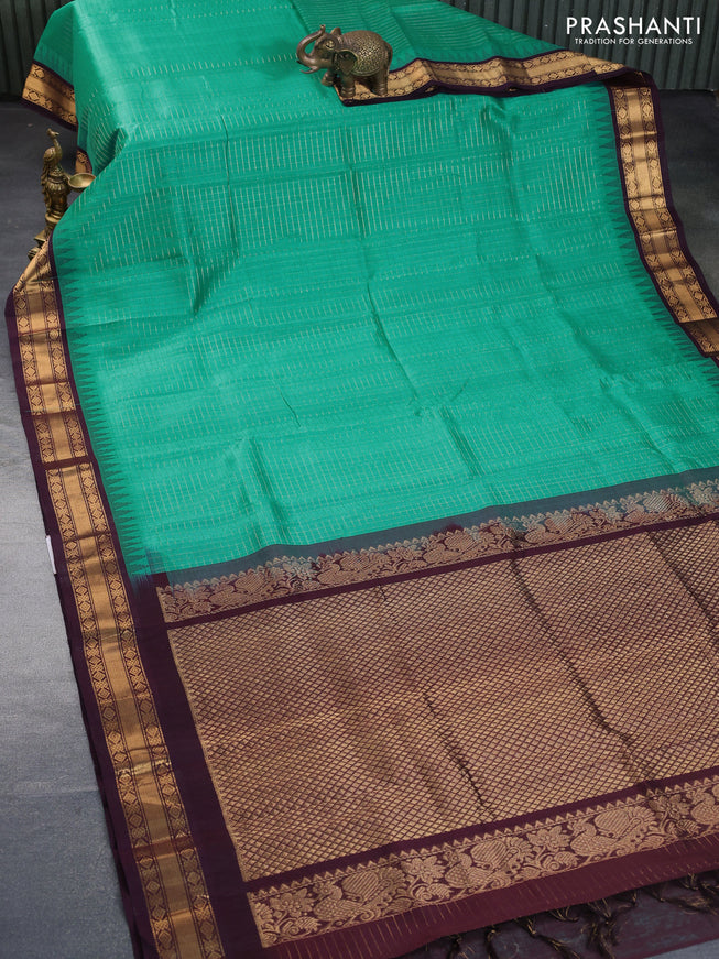 Silk cotton saree teal green shade and coffee brown with allover zari checked pattern and temple zari woven korvai border