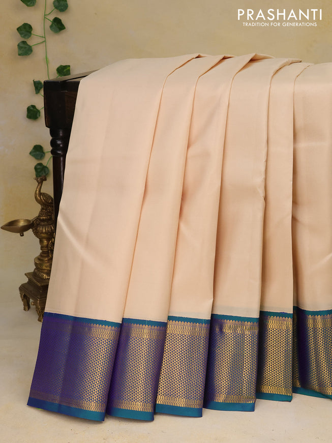 Pure kanchipuram silk saree cream and dual shade of bluish green with zari woven buttas and zari woven border