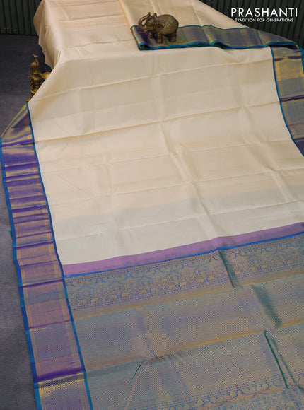 Pure kanchipuram silk saree cream and dual shade of bluish green with zari woven buttas and zari woven border