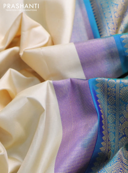 Pure kanchipuram silk saree cream and dual shade of bluish green with zari woven buttas and zari woven border