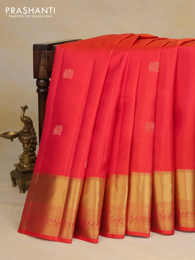 Pure kanchipuram silk saree dual shade of pinkish orange and teal blue with annam zari woven buttas and zari woven border