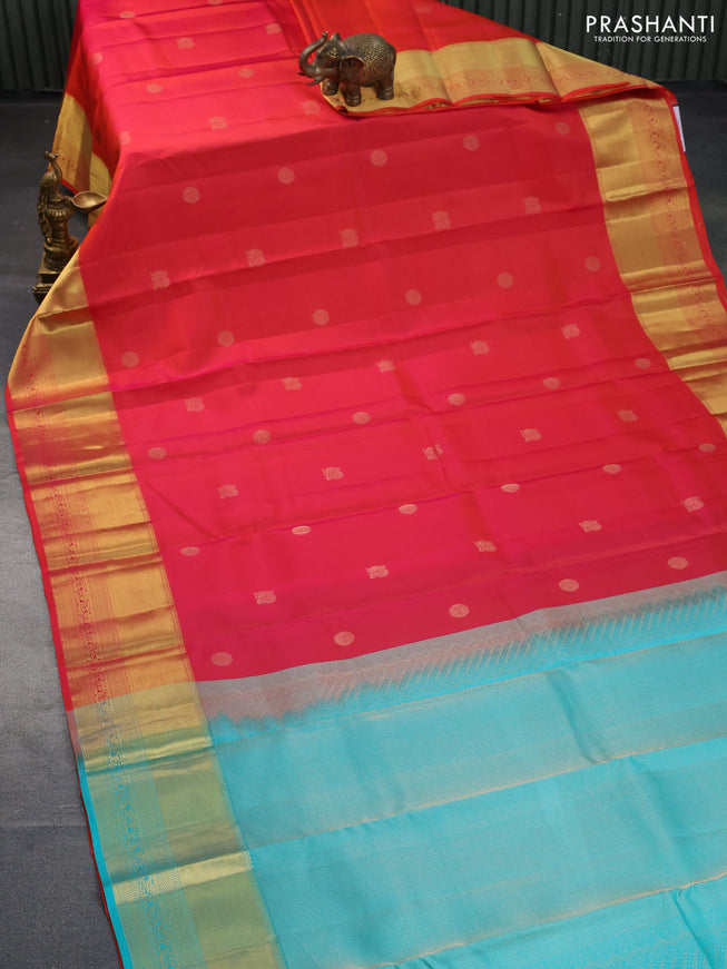 Pure kanchipuram silk saree dual shade of pinkish orange and teal blue with annam zari woven buttas and zari woven border