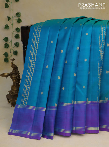 Pure kanchipuram silk saree dual shade of teal blue and dual shade of purple with zari woven buttas and rettapet zari woven border