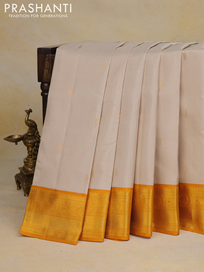 Pure kanchipuram silk saree beige and mustard yellow with zari woven buttas and zari woven korvai border