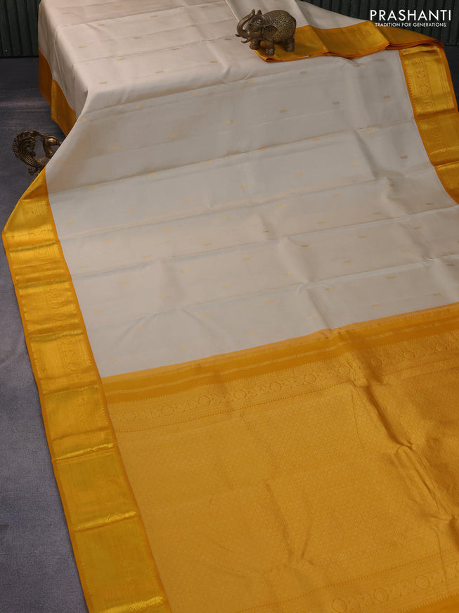 Pure kanchipuram silk saree beige and mustard yellow with zari woven buttas and zari woven korvai border